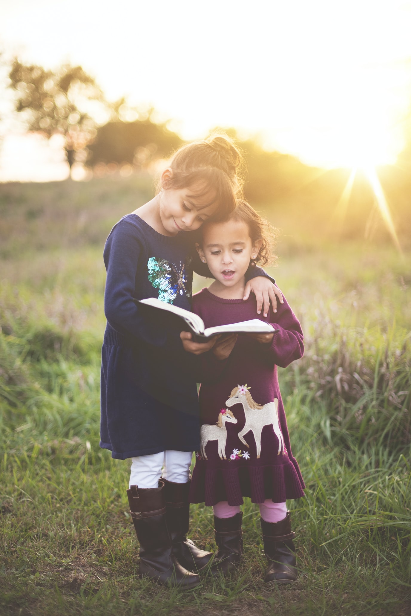girls reading to each other